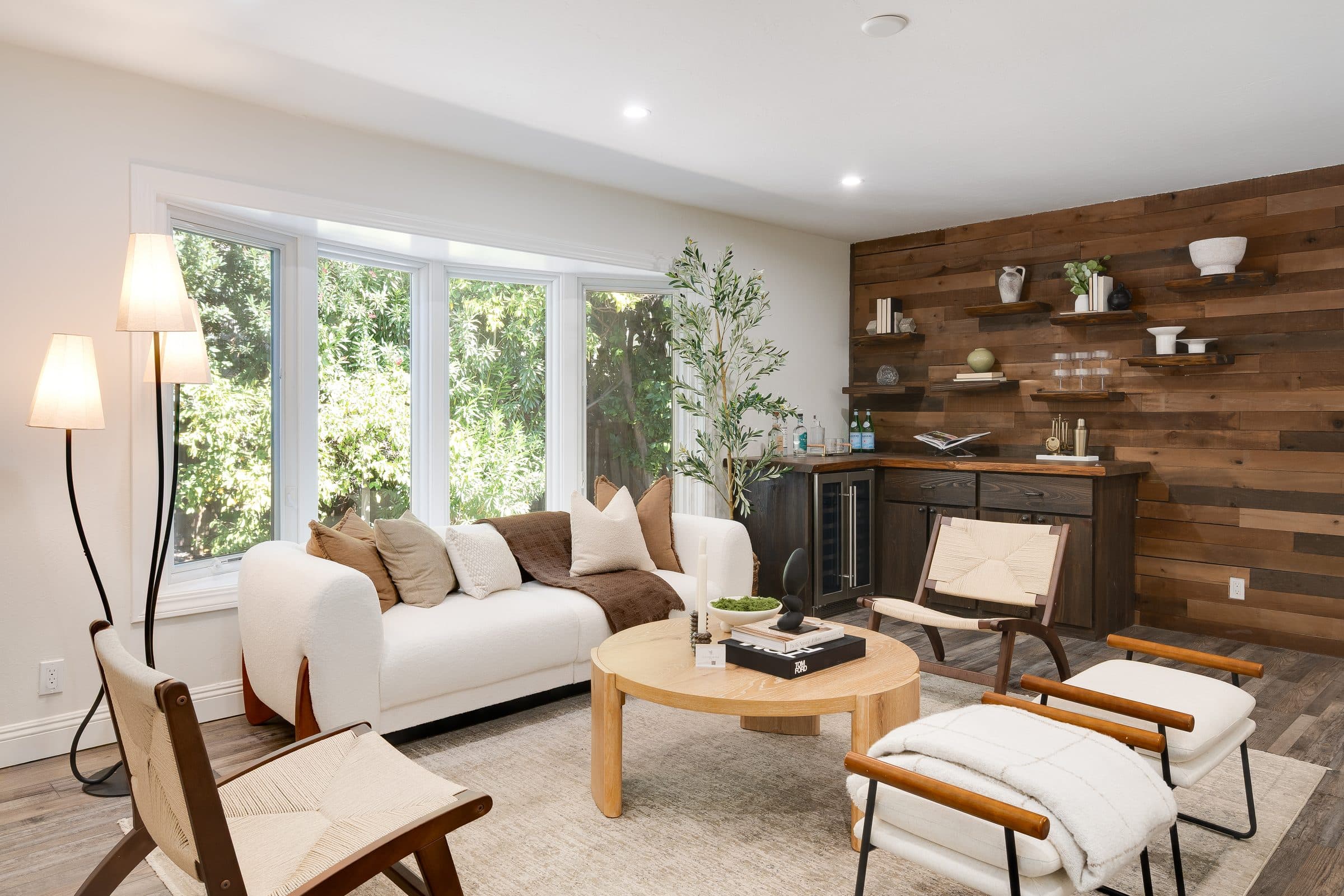 48 Kingston Place. The living room, its windows and wood-paneled wall.